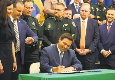  ?? Ricardo Ramirez Buxeda / Tribune News Service ?? Gov. Ron DeSantis signed the bill live on the ÊFoï I FriendsË show, with no other media outlets allowed.