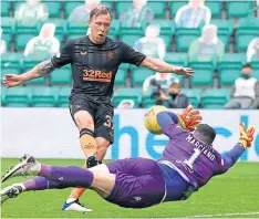  ??  ?? Ofir Marciano made a dramatic double save to deny Rangers’ Scott Arfield at Easter Road last Sunday