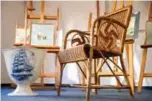  ??  ?? A picture shows a wicker armchair, bearing a swastika, and a vase which are presumed to have belonged to late Nazi dictator Adolf Hitler. — AFP photos
