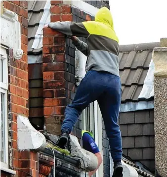  ??  ?? Climb: Hooded youngster refused to come down from the roof for eight hours