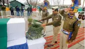  ?? — PTI ?? An officer pays tribute to CRPF jawan Mohammad Mujahid Khan, in Srinagar on Tuesday.