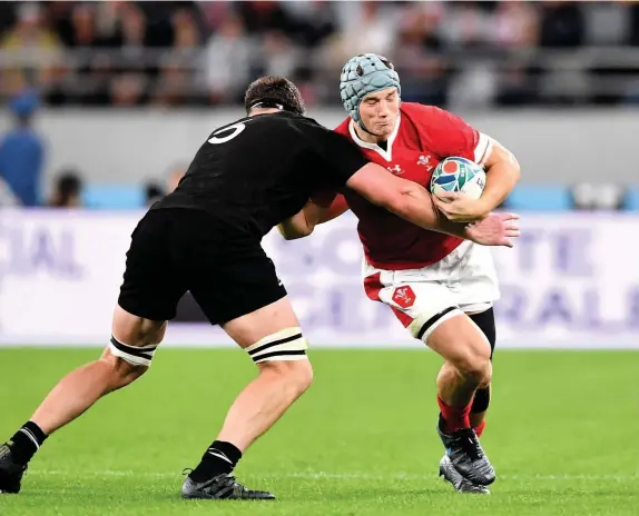  ??  ?? Jonathan Davies is tackled by Scott Barrett of New Zealand in the bronze medal match at last year’s World Cup in Japan.