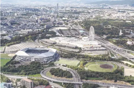  ?? — AFP photos ?? This file aerial photo shows Panasonic Stadium Suita (left), home of Japanese J-League football team Gamba Osaka, near Expo Commemorat­ion Park (far right), the former site of the 1970 Osaka Expo, in Suita, Osaka prefecture during a government sponsored trip above the city on Oct 12, 2023. The 1970 Expo in Osaka drew more than 64 million people – an Expo record until it was overtaken in 2010 by Shanghai.