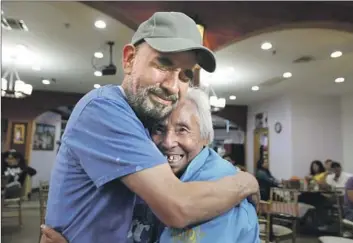  ?? Raul Roa Los Angeles Times ?? AFTER 34 years of not seeing her, Alberto Martinez hugs mom Irene Hernandez Mejia, visiting from Mexico.