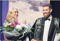  ?? PHOTO: NICOLE SHARP ?? What dreams are made of . . . Logan Wallace, supported by partner Penny Hicks, soaks up the win after being crowned the 2018 FMG Young Farmer of the Year at ILT Stadium Southland in Invercargi­ll on Saturday night.