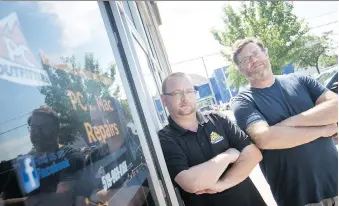  ?? DAX MELMER ?? PC Outfitters employee Brian Gallant and owner Trevor Sampson spent Tuesday cleaning up the mess inside the store after a thief rammed it with a minivan.