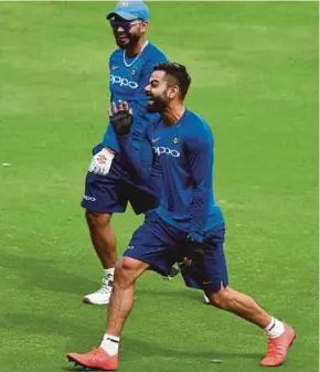  ?? AFP PIC ?? India captain Virat Kohli (right) and Rishabh Pant share a light moment during a practice session yesterday.