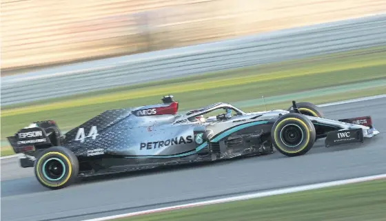  ??  ?? Mercedes’ Lewis Hamilton tests his latest car on the circuit in Barcelona.