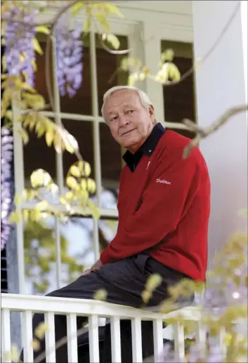  ??  ?? In this April 5, 2004, file photo, former Masters champion Arnold Palmer sits on clubhouse railing at the Augusta National Golf Club in Augusta, Ga. AP PHOTO