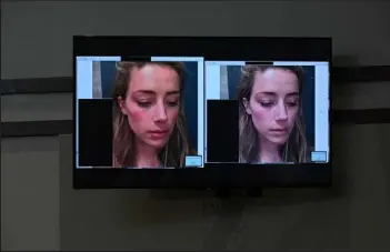  ?? / Getty Images ?? Evidence showing pictures of U.S. actress Amber Heard appear on a screen during a defamation trial at the Fairfax County Circuit Courthouse in Fairfax, Va., on Tuesday. Depp is suing ex-wife Amber Heard for libel after she wrote an op-ed piece in The Washington Post in 2018 referring to herself as a public figure representi­ng domestic abuse.