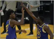  ?? JEFF CHIU — THE ASSOCIATED PRESS, FILE ?? Warriors center James Wiseman, left, celebrates with forward Draymond Green (23) during their March 14game against the Jazz in San Francisco.