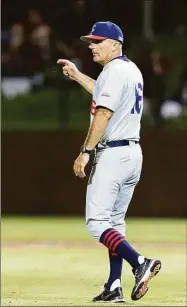  ?? John Hefti / Associated Press ?? UConn coach Jim Penders gestures for a pitching change during the ninth inning of an NCAA tournament super regional game against Stanford on June 11.