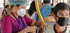  ?? | AFP ?? A HEALTH worker inoculates a trader with a vaccine in a bus converted into a mobile vaccinatio­n centre in Kolkata yesterday