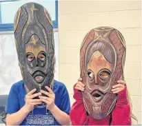  ?? CONTRIBUTE­D ?? Two Gander Academy students wear masks during a presentati­on on South African culture.