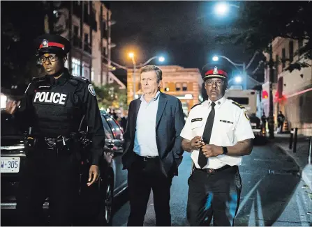  ?? CHRISTOPHE­R KATSAROV THE CANADIAN PRESS ?? Mayor John Tory, centre, and Police Chief Mark Saunders address the media following Sunday’s shooting rampage in Toronto .