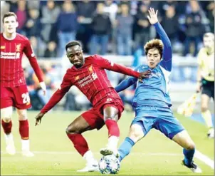  ?? AFP ?? Naby Keita of Liverpool (left) fights for the ball with RC Genk’s Junya Ito during the Uefa Champions League Group E match at the Luminus Arena in Genk on Wednesday.