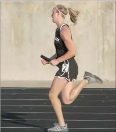  ??  ?? Mikaela Cochrane sprinting during a relay at the district track meet. Cochrane was a double winner (shot put and discus) and was the team high point leader with 28 points.