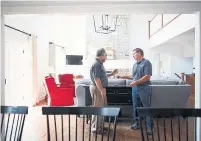  ?? COLE BURSTON/TORONTO STAR FILE PHOTO ?? Homeowner Marc Fortier, left, last year moved into his Net-Zero Ready home, built by Steve Snider in Durham Region.