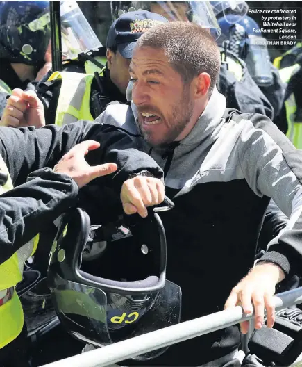  ?? JONATHAN BRADY ?? Police are confronted by protesters in Whitehall near Parliament Square, London