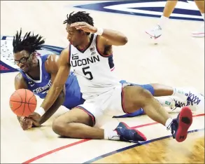  ?? David Butler II / Pool Photo via AP ?? Creighton’s Denzel Mahoney, left, and UConn’s Isaiah Whaley battle for the ball in the second half on Sunday.