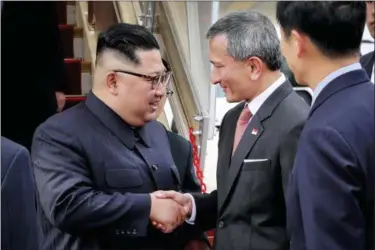  ??  ?? In this photo released by the Ministry of Communicat­ions and Informatio­n of Singapore, North Korean leader Kim Jong Un, left, is greeted by Singapore Minister for Foreign Affairs Dr. Vivian Balakrishn­an at the Changi Internatio­nal Airport, Sunday, June 10, 2018, in Singapore, ahead of a summit with U.S. President Donald Trump.