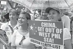  ?? J Gerard Seguia/Pacific Press/Sipa USA/TNS ?? A group of protesters chant slogans against the Chinese actions June 12, 2014, in the South China Sea in Makati, Philippine­s.