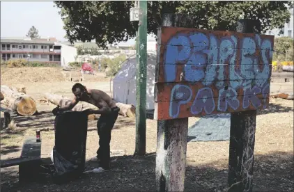  ?? RISBERG AP PHOTO/ERIC ?? A homeless man gathers up debris at People’s Park in Berkeley, Calif., in 2022.