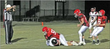  ?? MARK HUMPHREY ENTERPRISE-LEADER ?? Farmington freshman Alec Duncan tackles the junior Blackhawks’ punter on a mishandled snap inside the 5-yard line. Farmington converted the turnover on downs into what turned out to be the game-winning touchdown in a tough contest against Pea Ridge on Thursday, Sept. 13. The junior Cardinals were victorious, 28-22, in a game that wasn’t decided until a Farmington intercepti­on in the closing seconds.