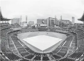  ?? PHOTOS BY HAKIM WRIGHT SR. AP ?? Truist Park was practicall­y empty during a rain delay in the fifth inning Sunday. The Marlins and Braves were able to resume the game after a wait of one hour and 51 minutes.