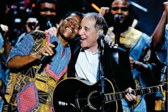  ??  ?? REUNION: Simon plays with Ladysmith Black Mambazo’s Joseph Shabalala in Washington in 2007