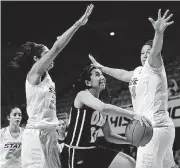  ?? [PHOTO BY TYLER DRABEK, FOR THE OKLAHOMAN] ?? Oral Roberts guard Ashley Beatty drives past two defenders to against Oklahoma State in 2015. Beatty, 20, died Thursday on ORU’s campus.