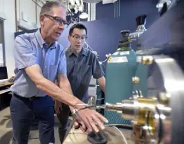  ?? Cliff Grassmick, Daily Camera ?? Dr. Tim Minton, left, and Dr. Chenbiao Xu, both of the University of Colorado Boulder, work with a laser during their hypersonic research on Friday.