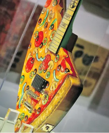  ?? — PHOTOS: THE ASSOCIATED PRESS ?? The Pizza Guitar, from musician Andrew W.K., is another artistic slice of the exhibit at New York’s Museum of Pizza.