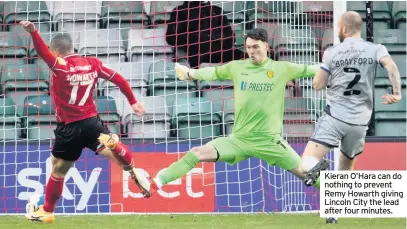  ??  ?? Kieran O’Hara can do nothing to prevent Remy Howarth giving Lincoln City the lead after four minutes.