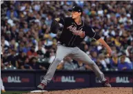  ?? Stacy Revere / Getty Images ?? Braves starter Max Fried pitches in the fourth inning of Game 2 of the NLDS against the Brewers on Saturday in Milwaukee.