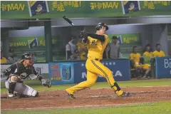  ?? BILLY H.C. KWOK/NEW YORK TIMES ?? A player for the Chinatrust Brothers bats during a May 11 game against the Uni-President Lions in Taiwan.