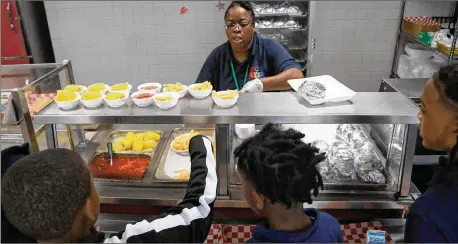 ?? SAVANNAH MORNING NEWS PHOTOS ?? Students at Georgetown K-8 select their lunch. A nutritiona­l audit was conducted between February and June this year. It included a districtwi­de physical audit and onsite observatio­ns of the ordering and receiving processes, according to the audit memo.