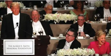  ?? SPENCER PLATT/GETTY IMAGES ?? Presidenti­al candidate Donald Trump speaks at the 71st Annual Alfred E. Smith Memorial Foundation Dinner as Hillary Clinton laughs at his comments.