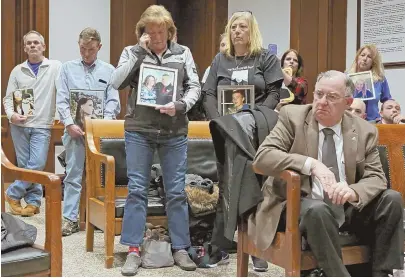  ?? STAFF PHOTO BY ANGELA ROWLINGS ?? WANTING THEIR VOICES HEARD: Family members and friends, above, of several young adults who died of drug overdoses stand with photos of the deceased during a hearing at the State House yesterday. Cheryl Juaire of Marlboro, right, testifies yesterday...