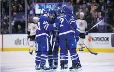  ?? COLE BURSTON/THE CANADIAN PRESS/FILES ?? Toronto Maple Leafs teammates celebrate during a game against the Boston Bruins on Feb. 24 in Toronto. The Leafs won that game, and took the season series 3-1.