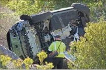  ?? AP-Marcio Jose Sanchez, File ?? In this Feb. 23 file photo, a vehicle rests on its side after a rollover accident involving golfer Tiger Woods, in Rancho Palos Verdes, Calif.