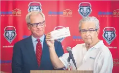  ?? ROBERTO E. ROSALES/JOURNAL ?? Dreamstyle Remodeling CEO Larry Chavez presents a $1 million check to UNM athletic director Paul Krebs on Wednesday.