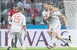  ?? MANU FERNANDEZ — THE ASSOCIATED PRESS ?? Nacho, right, celebrates with teammates after giving Spain a 3-2 lead over Portugal in the second half of Friday’s Group B match at the World Cup in Russia.