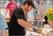  ?? TIM COOK/THE DAY ?? Barbecue Pit Master Pete Daversa of East Lyme runs his barbecue stand at the Niantic Farmers Market last July. He would have been the chef at the planned restaurant.