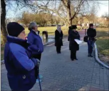  ??  ?? Daughters of the American Revolution held a wreath-laying ceremony Friday to remember those who perished during the Japanese attack on Pearl Harbor.