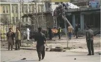  ??  ?? Security personnel inspect a site in Kabul after a suicide bomber targeting Afghanista­n’s minority Hazaras blew himself up at a police checkpoint on Friday, killing 10 people, officials said.