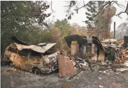  ?? Peter Parks / AFP / Getty Images ?? The torched shells of a house and vehicle remain after a wildfire ravaged Bilpin, Australia.