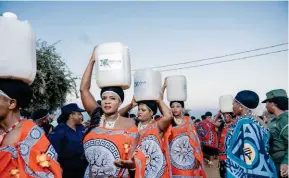  ?? ?? ▲ Members of Lutsango on their way to deliver gifts at the Buganu Festival at Hlane Royal Residence.