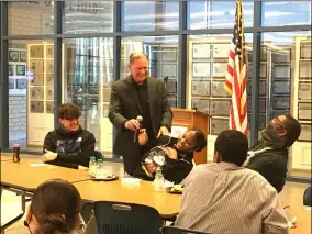  ?? ?? Lorain High School 10th grader Tanaya Smith laughs as Mayor Jack Bradley passes her the microphone during the breakfast kickoff of oneLHS, a new club for students of all classes to focus on positivity and pride in their school and community.