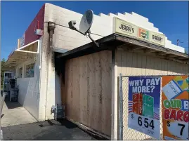  ?? KYRA GOTTESMAN — MERCURY-REGISTER ?? The storage room of Jerry’s Market, at the corner of Oroville Dam Boulevard and Bridge Street, was destroyed Wednesday night when a high-speed chase ended with the driver of a Honda Accord fleeing from CHP crashed into the store. The store was open for business Thursday after debris had been cleared from the parking lot and the front of the storage room had been secured with plywood.